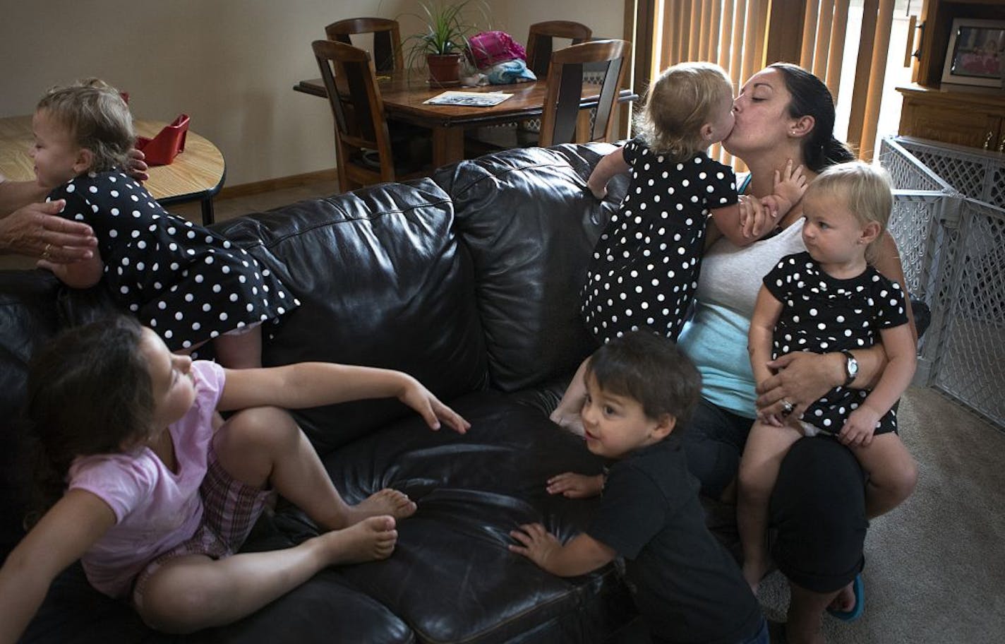 Ashley Broskoff kissed daughter Raegan while holding Lia on her lap. The other children are big sis Presley, lower left, who's 5; Hattie, left, and Shay.