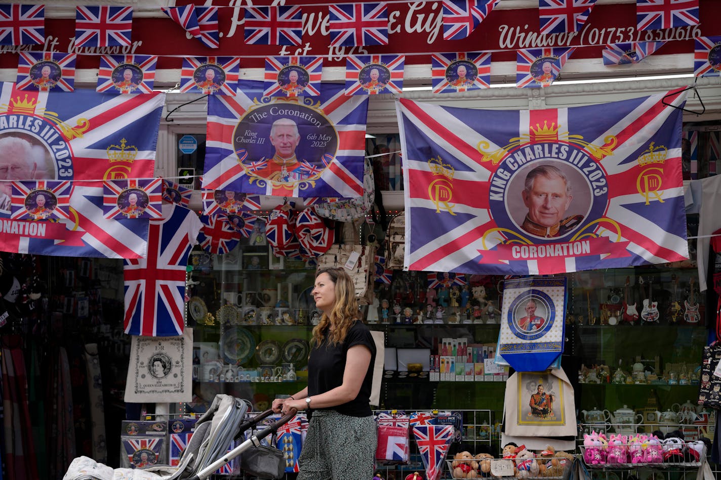 A woman looks at King Charles coronation memorabilia on sale at a shop in Windsor, England on Friday