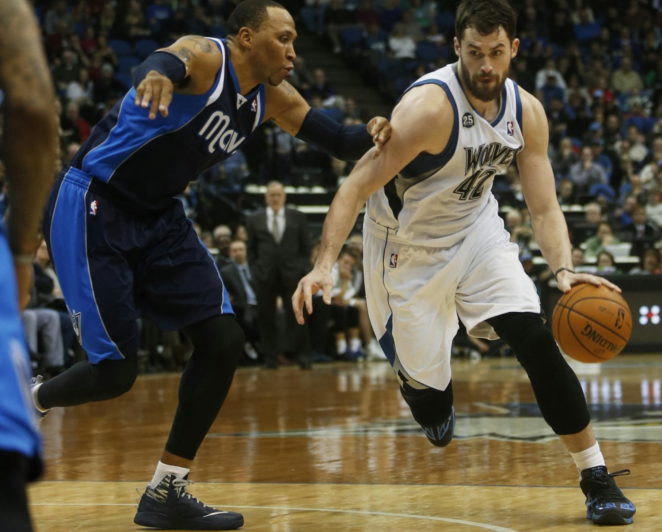 At the Target Center in a game between Dallas and the Wolves, Kevin Love(42) drives onShawn Marion(0).