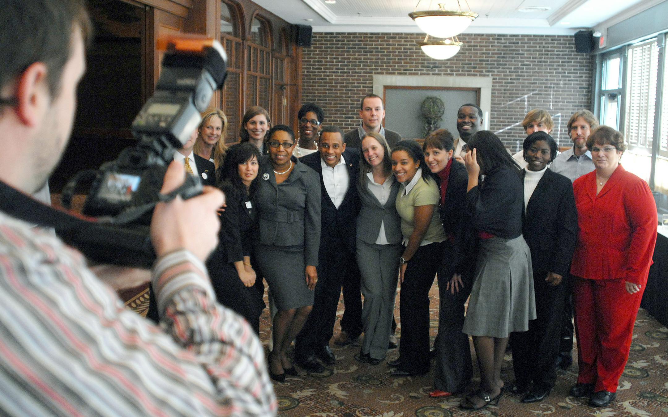 Big Brothers Big Sisters staff poses for a picture on Friday at the Metropolitan Ballroom in Golden Valley, Minn.