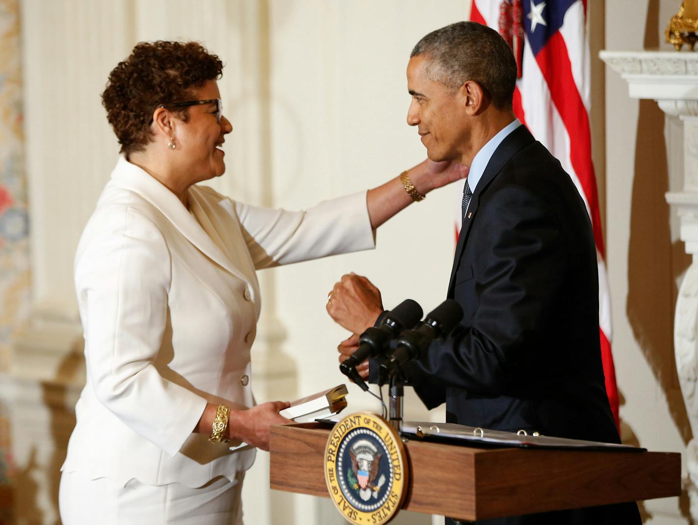 President Barack Obama introduces poet laureate Elizabeth Alexander for a poetry reading, Friday, April 17, 2015, in the State Dining Room of the White House in Washington. Alexander read "Praise Song for the Day" during President Obama's 2009 inauguration. (AP Photo/Andrew Harnik) ORG XMIT: DCAH101