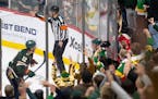 Matt Boldy (12) skates to congratulate Wild teammate Kirill Kaprizov after he scored his third goal of the game against the Sharks on Sunday at Xcel E