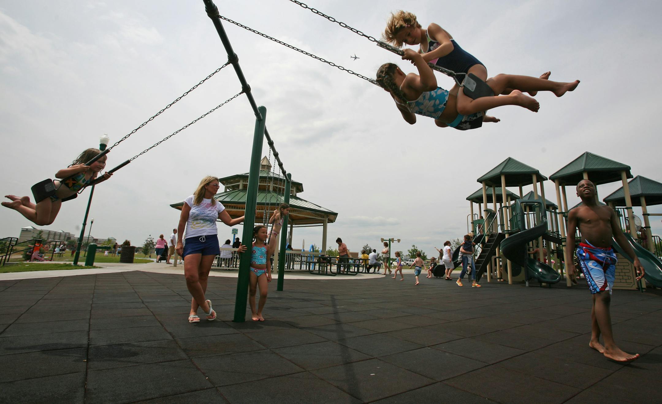 Hope Diamond, 7 and Abby Schoonver, 7, both of Apple Valley shared a swing at Kelly Park in Apple Valley Wednesday afternoon. The park was built in an area that had major plans for construction but plans have changed thanks to the housing market and the area around the park remains vacant.