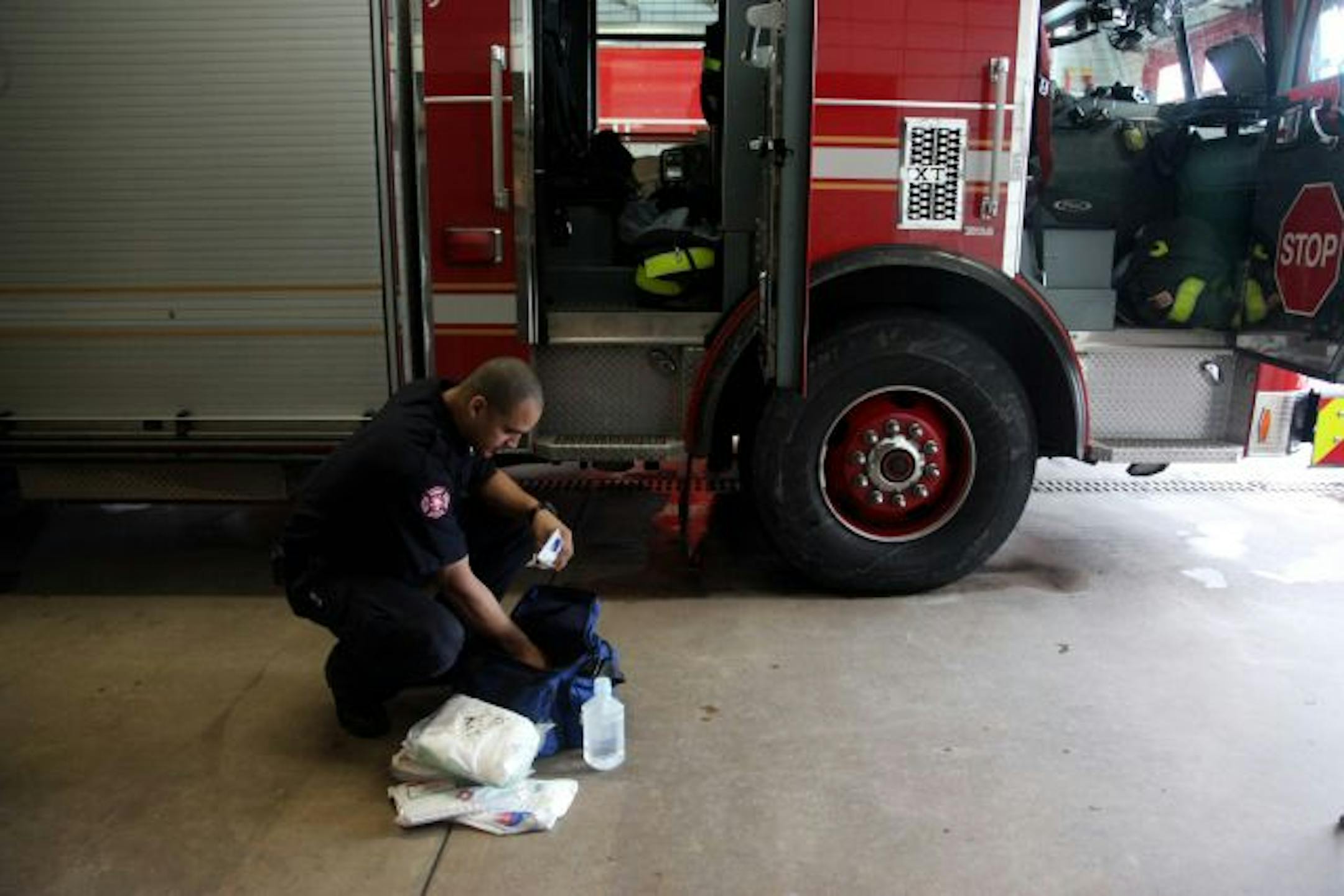 Minneapolis rookie firefighter Johnathon McClellan did an inventory check on rescue equipment as he worked a shift at Station 5 on Bloomington Avenue. Layoffs are a possibility. "I don't like to see anybody go out the door," Fire Chief Alex Jackson says.