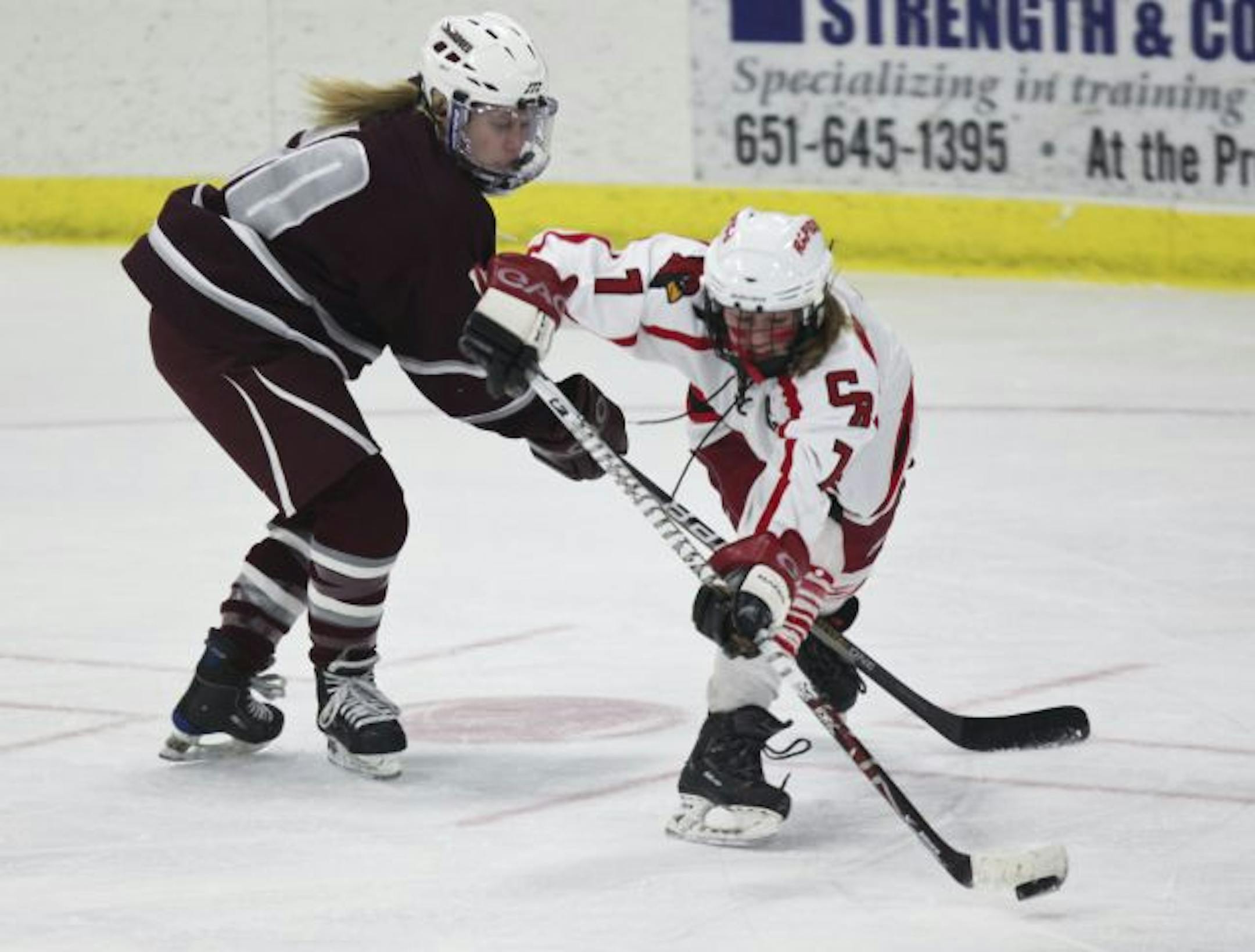 Bona fought for possession of the puck against Anoka's Katie Johnson.
