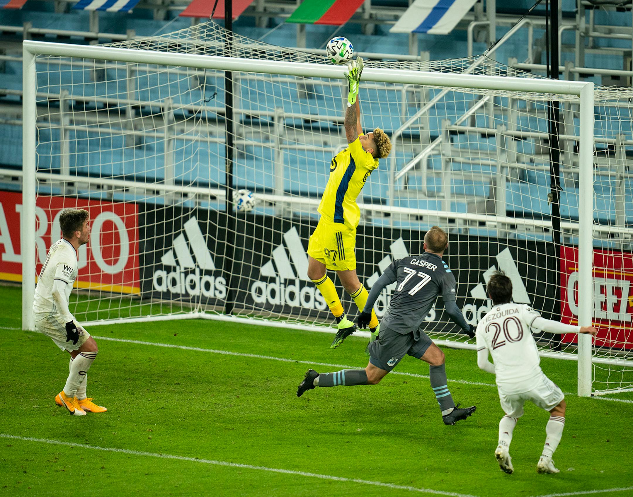 Minnesota United goalkeeper Dayne St. Clair (97) leapt to grab a second half corner kick. Minnesota United defender Chase Gasper (77) was in place to back him. up, while Colorado Rapids midfielder Nicolas Mezquida (20) was in place to play the ball had St. Clair not made the save.