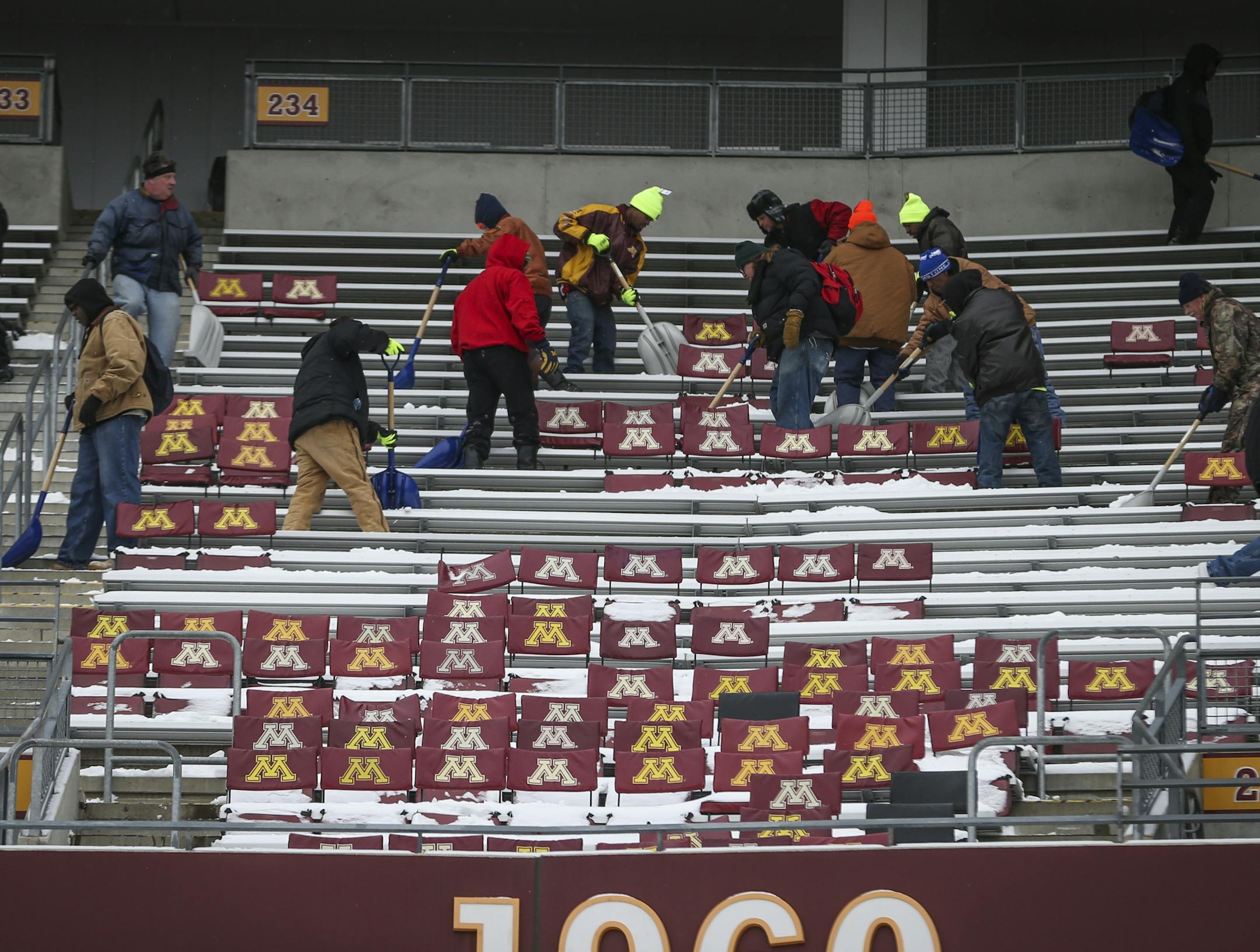 TCF Bank Stadium is buried in snow that must be removed by Saturday for the Gophers football game. People were hired to remove it on Wednesday, November 12, 2014 in Minneapolis, Minn. They used long chute to slide it down into the field to be hauled away. ] RENEE JONES SCHNEIDER • reneejones@startribune.com