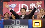 FILE - In this file photo taken Thursday, May 22, 2014, Liu Qiangdong, also known as Richard Liu, CEO of JD.com, raises his arms in 2014 to celebrate 