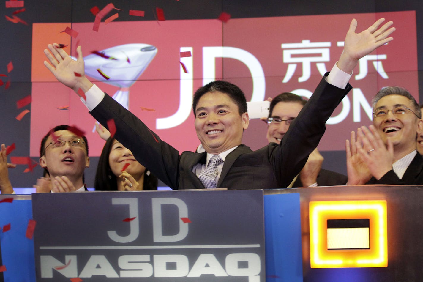 FILE - In this file photo taken Thursday, May 22, 2014, Liu Qiangdong, also known as Richard Liu, CEO of JD.com, raises his arms in 2014 to celebrate the IPO for his company at the Nasdaq MarketSite, in New York. JD.com, China's No. 2 e-commerce service, is headquartered in Beijing.