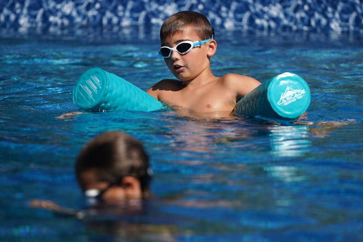 Jack Meyer, 9, lounged on a noodle in his aunt and uncle's newly installed in-ground pool Tuesday.