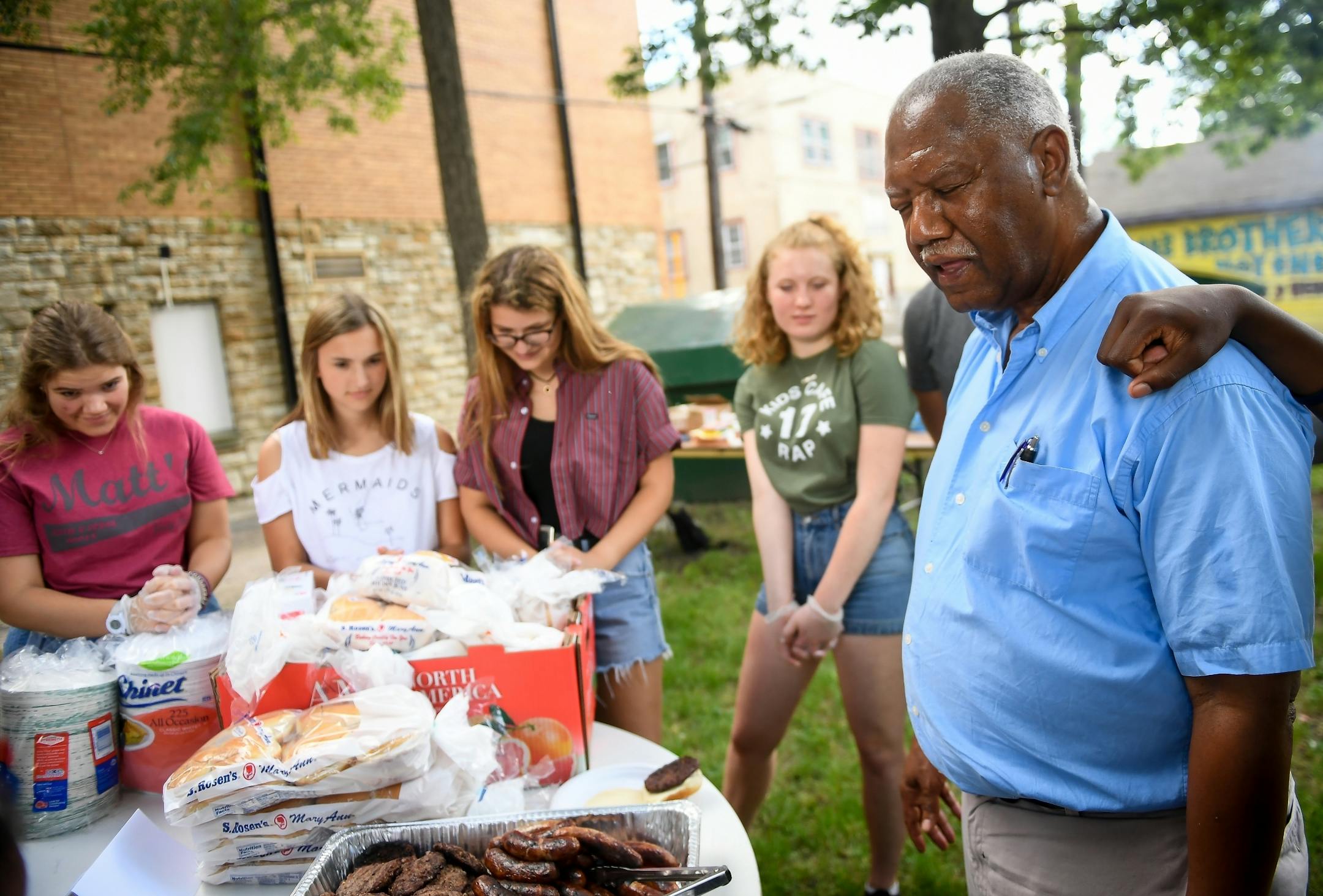 Rev. Kelly Chatman led a before-meal prayer during Wednesday night's community cookout at Redeemer Lutheran Church.