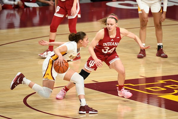 Gophers guard Amaya Battle, left, drove past Indiana guard Grace Berger on Feb. 1 at Williams Arena. Minnesota will pla at Wisconsin on Saturday.
