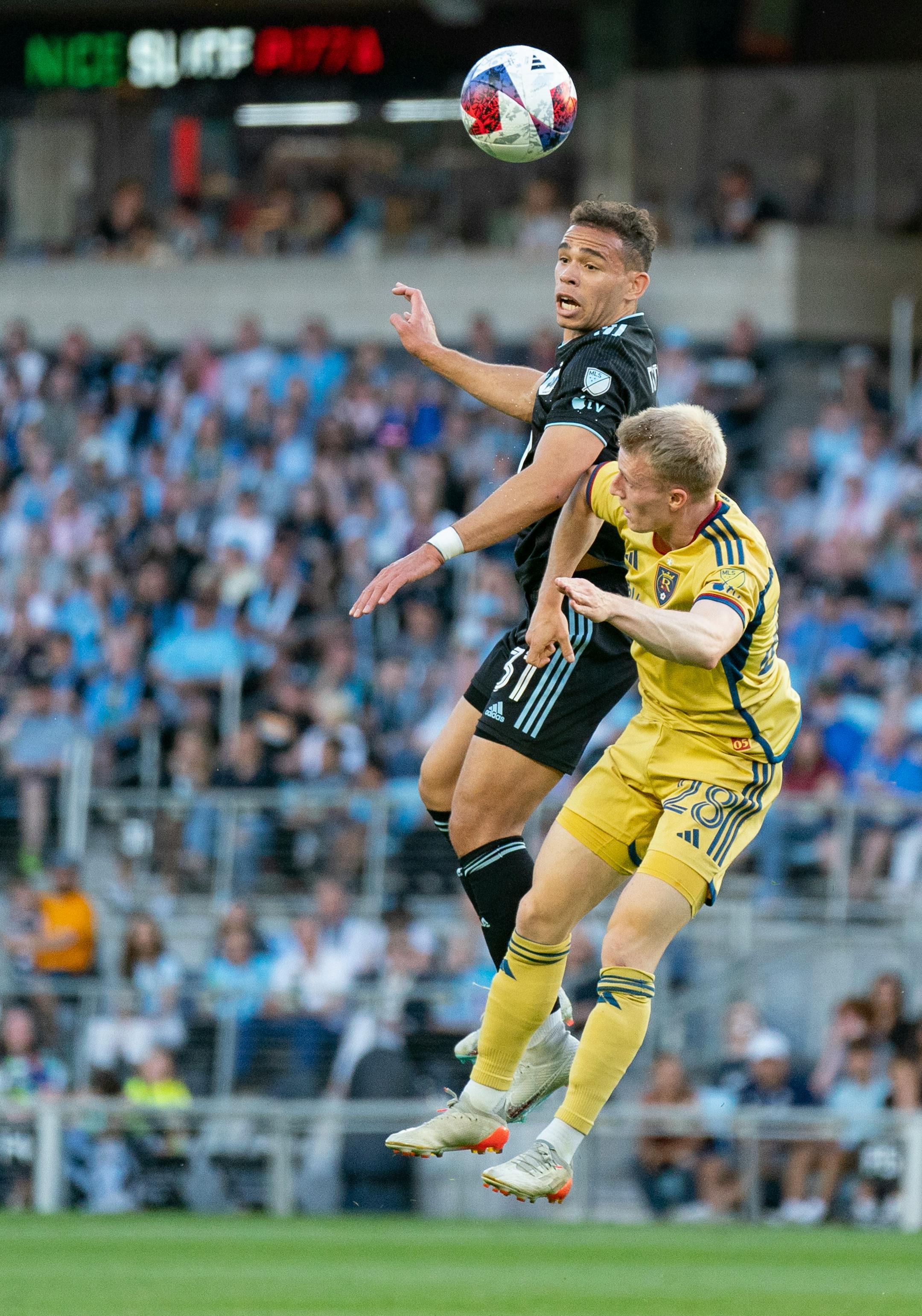Minnesota United midfielder Hassani Dotson (31) heads the ball over Real Salt Lake defender Jasper Löffelsend (28) in the first half.