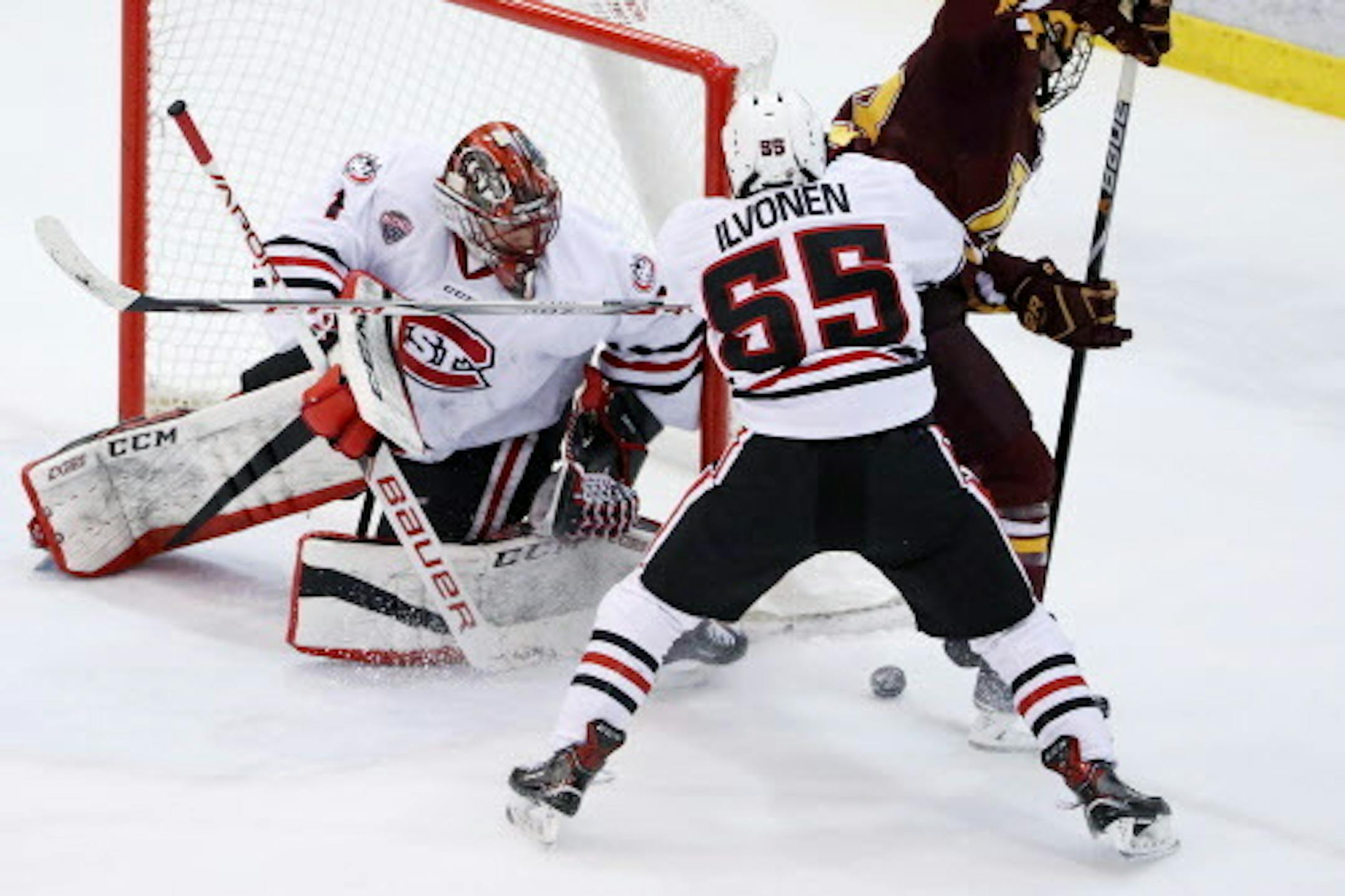 St. Cloud State Huskies defenseman Mika Ilvonen (55) shoved away Minnesota Golden Gophers forward Ryan Norman (23) as he looked to take a shot on St. Cloud State Huskies goaltender Jeff Smith (1) in the third period. ] ANTHONY SOUFFLE ' anthony.souffle@startribune.com