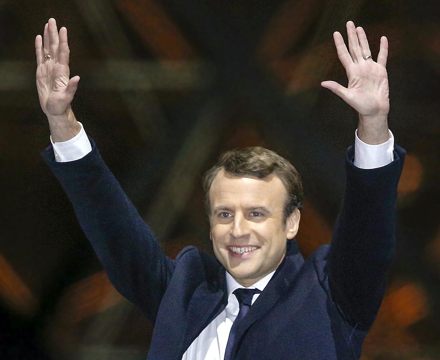 French President-elect Emmanuel Macron gestures during a victory celebration outside the Louvre museum in Paris, France, Sunday, May 7, 2017. Speaking to thousands of supporters from the Louvre Museum's courtyard, Macron said that France is facing an "immense task" to rebuild European unity, fix the economy and ensure security against extremist threats. (AP Photo/Thibault Camus) ORG XMIT: MIN2017050717095608 ORG XMIT: MIN1705071921040992