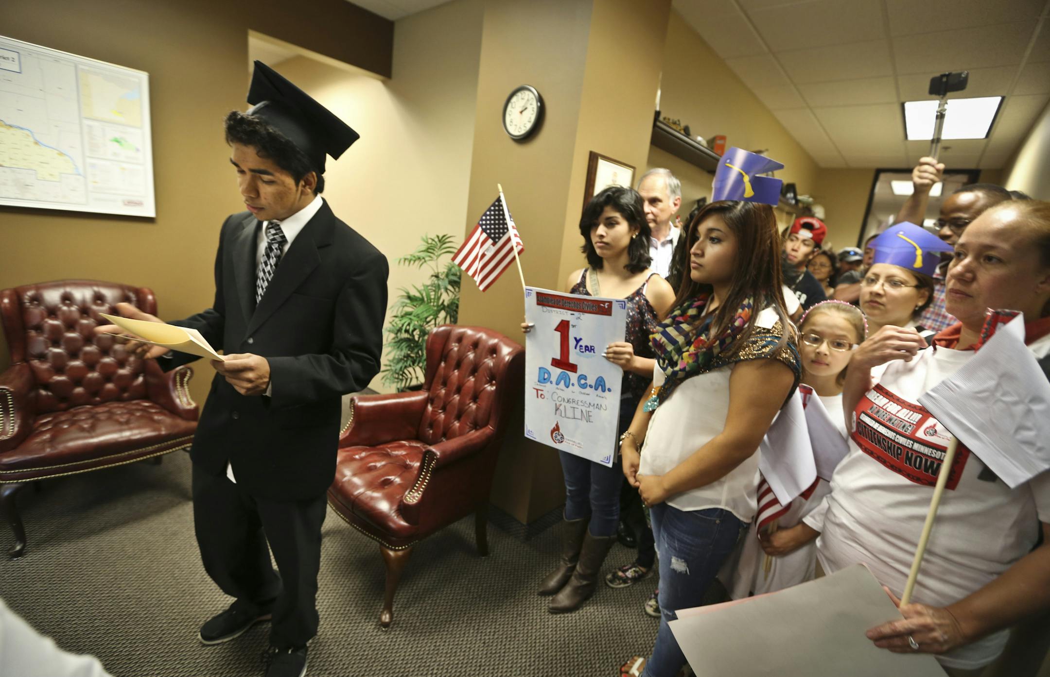 David Ramirez-Luna read his testimony on coming undocumented to the U.S. as a three-year-old to Chaz Johnson (constituent services), not pictured, at U.S. Representative Jim Kline office in Burnsville, Minn. as he and immigrant leaders and allies lead events celebrating anniversary of Deferred Action for Childhood Arrivals went spoke up to encourage more reform on Thursday, August 15, 2013. ] (RENEE JONES SCHNEIDER • reneejones@startribune.com)