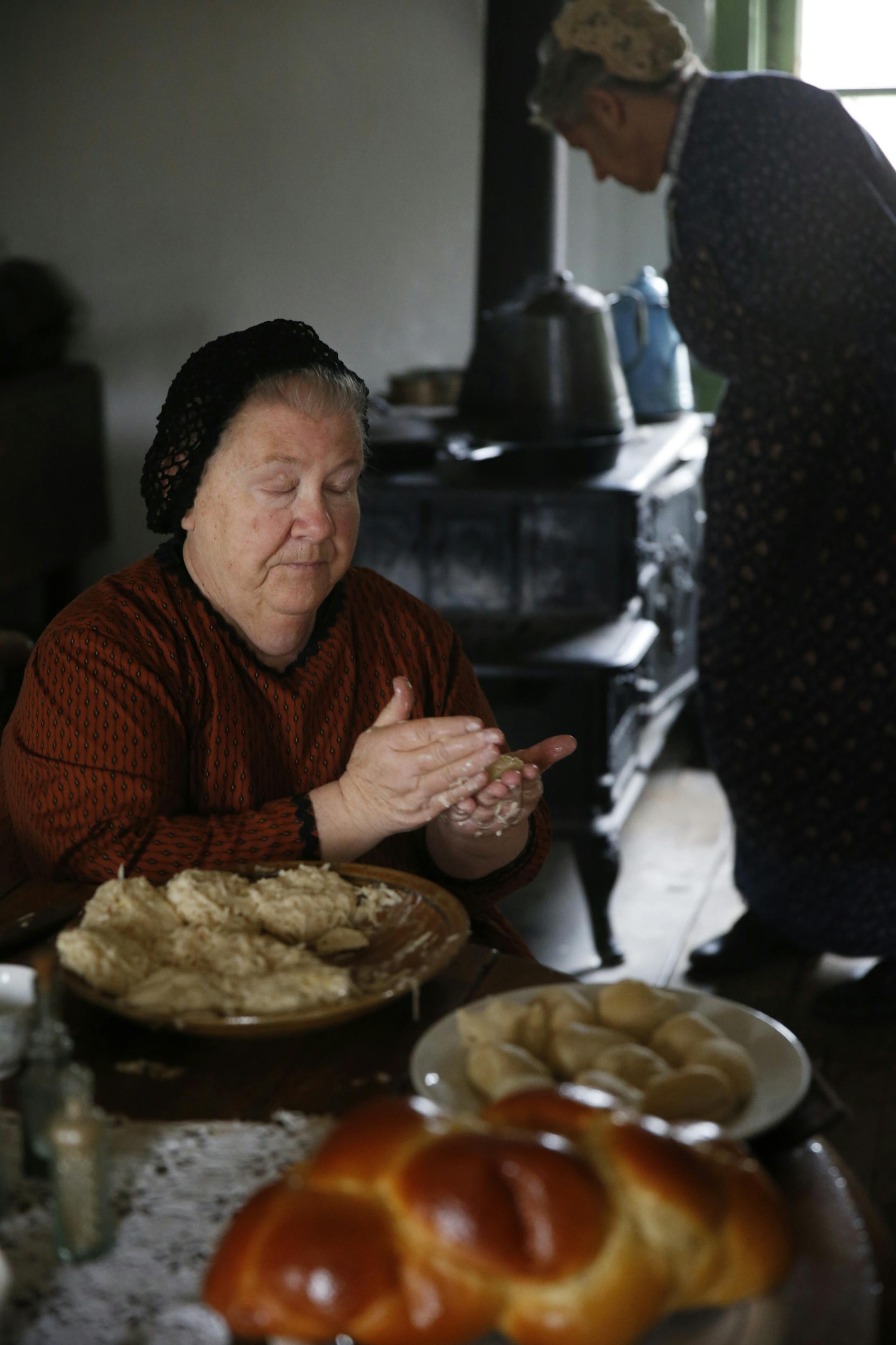 At the 41st Annual Foklways of the Holidays in Shakopee, Miryam Jacobi, left, and Mrs. Johnson played by Lynn Ehrke and Lorna Meyers respectively celebrate hannukah in the late 19th centruy. Jacobi is the wife of a Jewish doctor who is making latkes, a potato pancake for the holidays. Jews came from Chicago and abroad to settle the midwest in greater number in the late 19th century .]richard tsong-taatarii/rtsong-taatarii@startribune.com