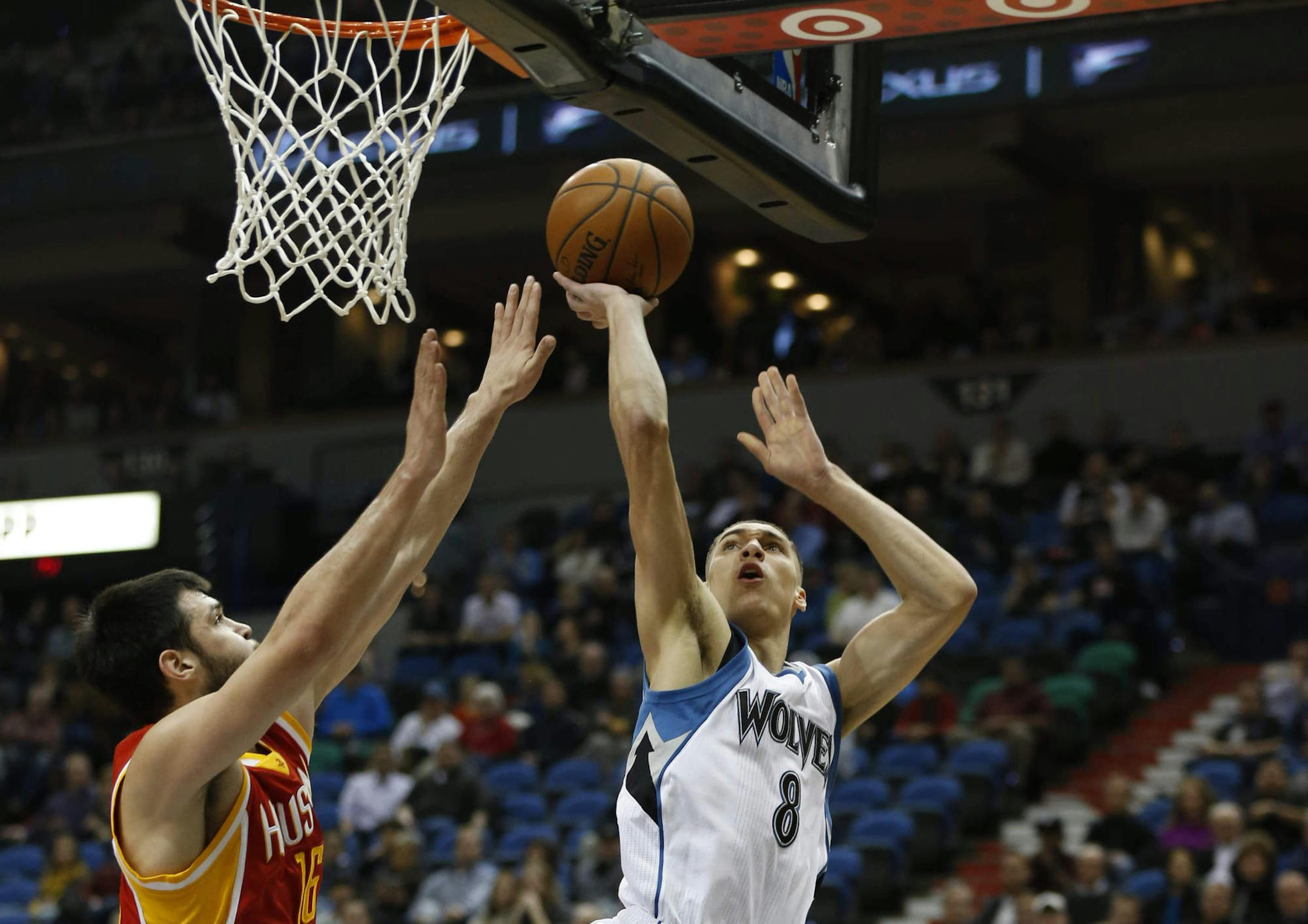 Minnesota Timberwolves guard Zach LaVine (8) shoots against Houston Rockets forward Kostas Papanikolaou (16) during the first half of an NBA basketball game Friday, Dec, 5, 2014, in Minneapolis. (AP Photo/Stacy Bengs)