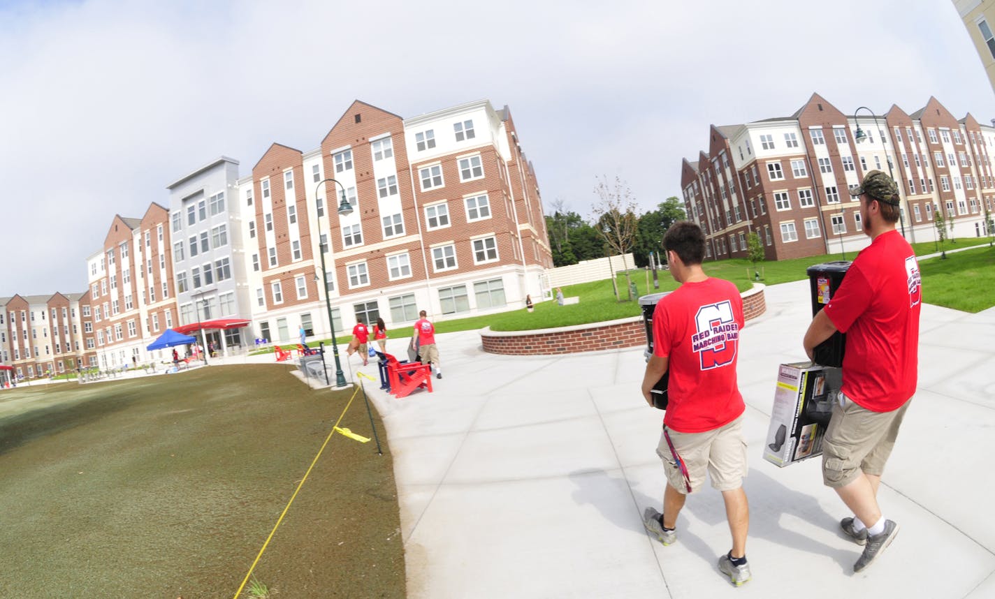 In this photo taken on Thursday, Aug. 21, 2014, orientation committee members move new student belongings into a dorm during move-in day at Shippensburg University in Shippensburg, Pa. (AP Photo/Public Opinion, Markell DeLoatch) HERALD-MAIL OUT; THE RECORD HERALD OUT