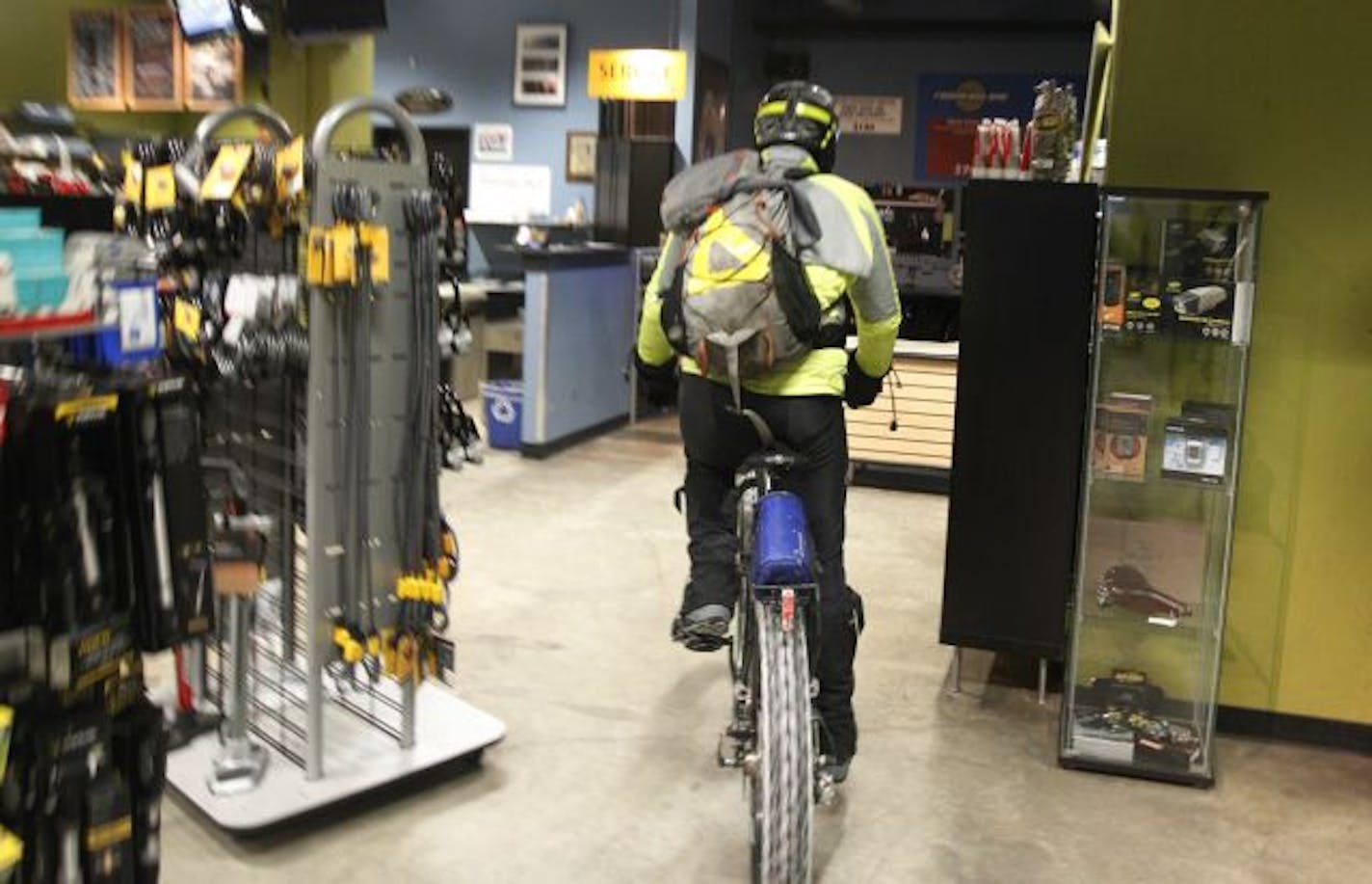 Tom Lais washes his bike and showers at the Midtown Bike Center in Minneapolis.