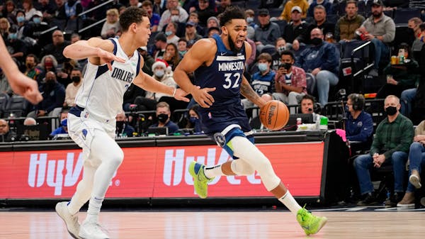 Karl-Anthony Towns of the Wolves got past Mavs center Dwight Powell on Sunday.