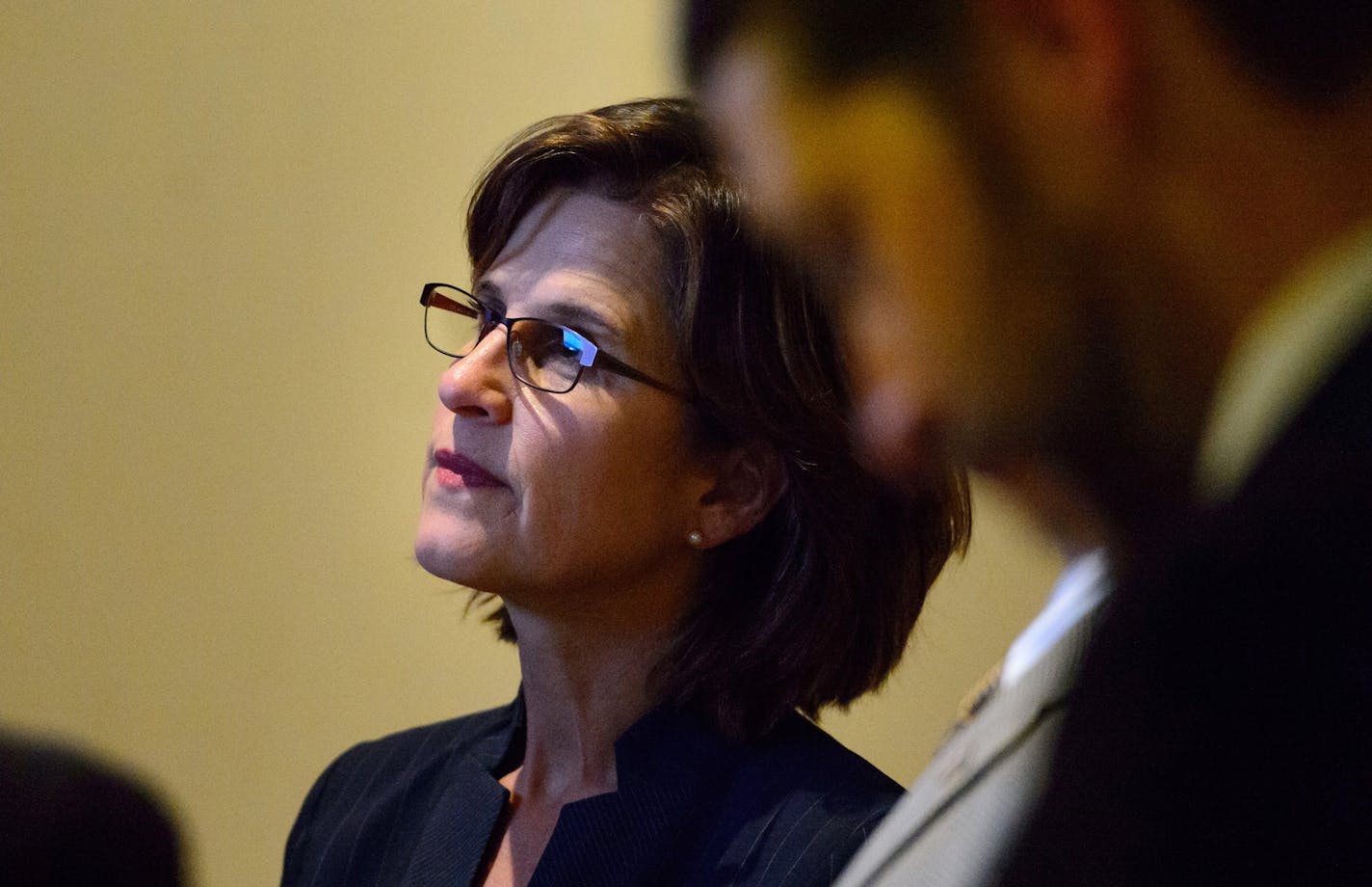 State Auditor Rebecca Otto watched the House proceedings in the hallway outside the chambers as her office was impacted by a surprise piece of legislation on the final day of the 2015 session.