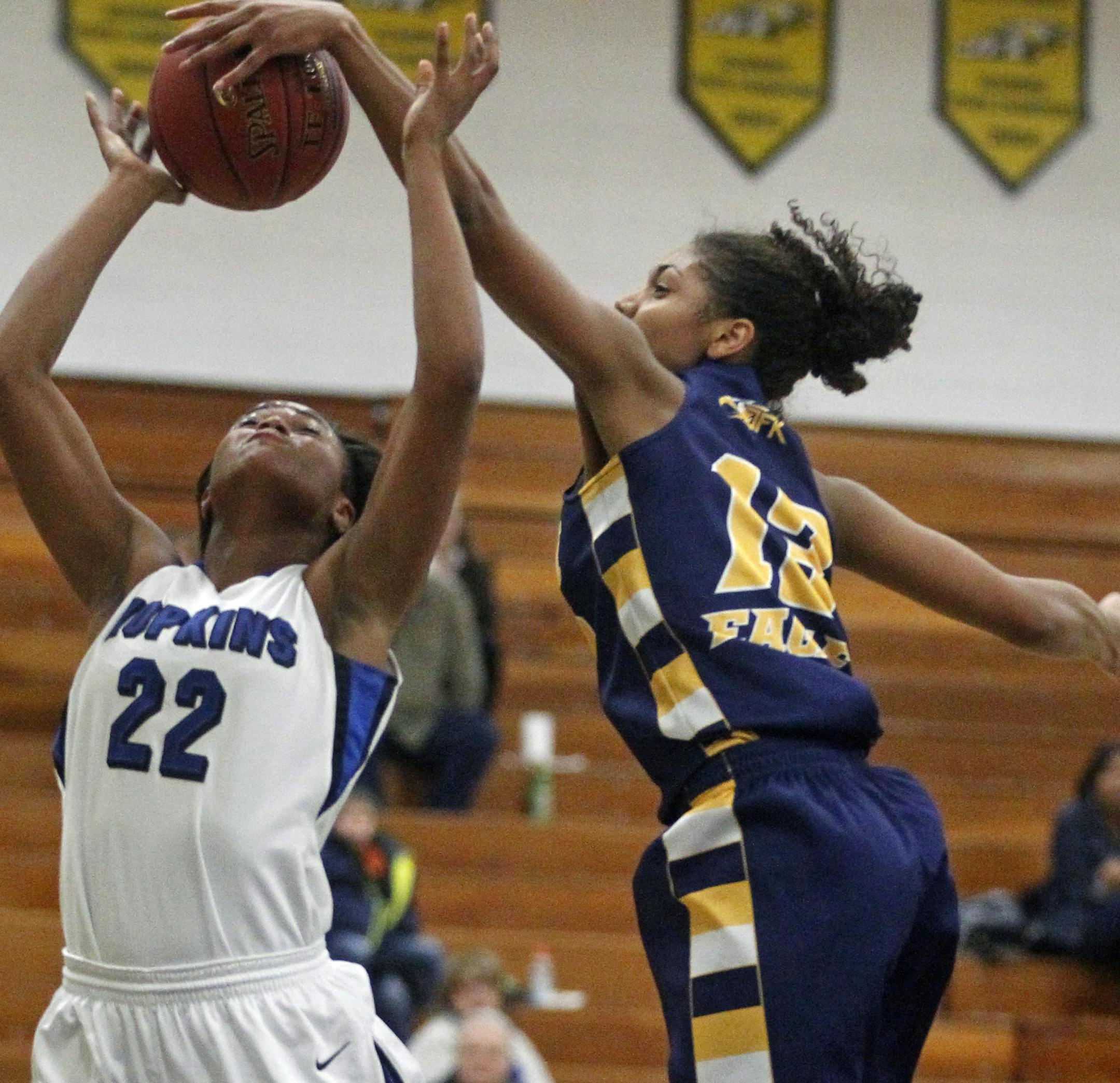 At Bloomington Kennedy, in a game between Kennedy and Hopkins, TT Starks(22) of Hopkins gets her shot altered by Jade Martin(13).] rtsong-taatarii@startribune.com