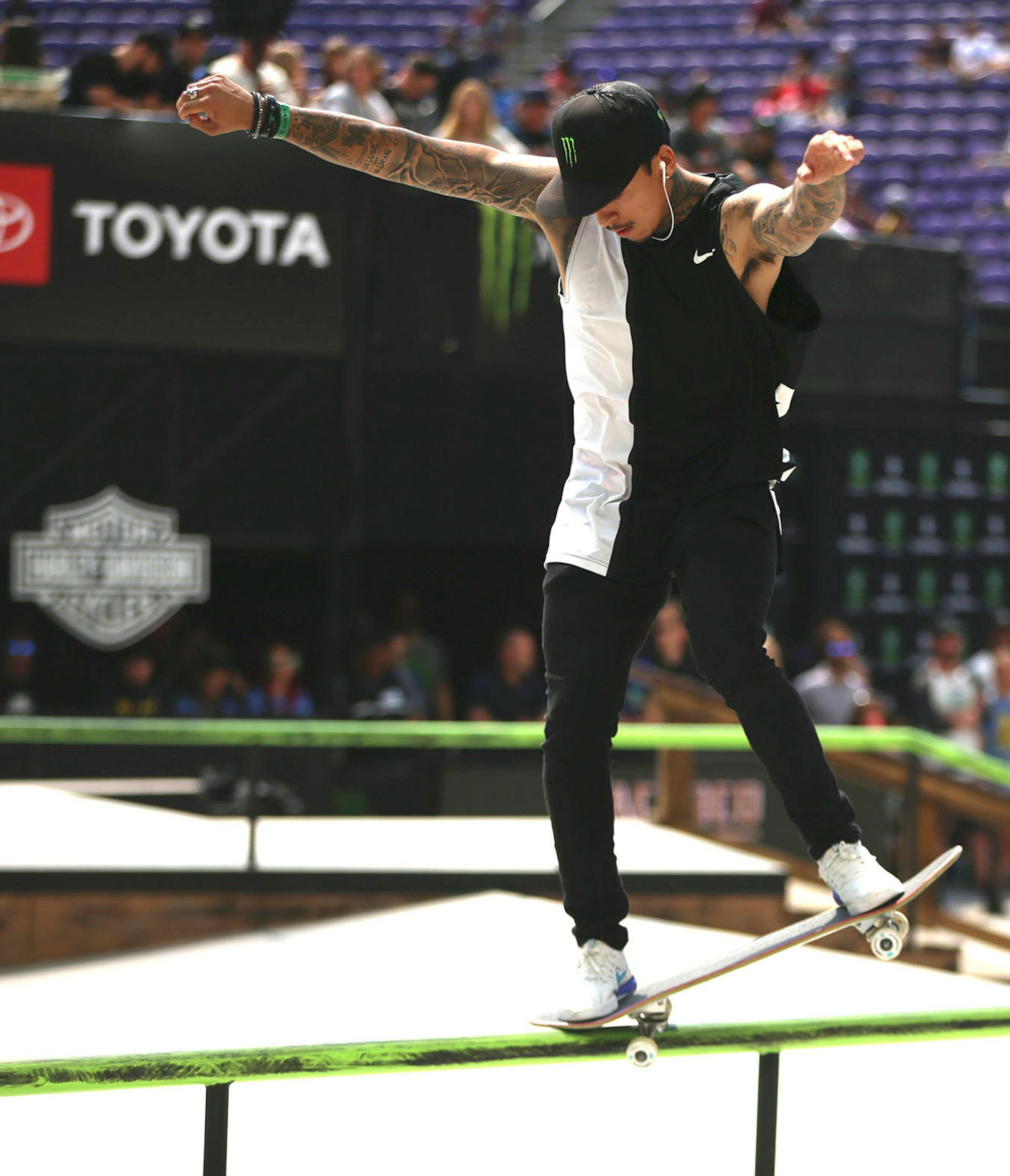 Nyjah Huston, the eventual gold medal winner, glides on a railing in the men's skateboard street final.