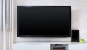 Large flat screen TV mounted to the wall in modern interior living room. istock photo
