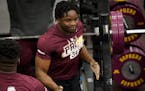 Defensive lineman Boye Mafe got a hand after benching 225 pounds 21 times during the Gophers annual pro day before NFL scouts on March 16.