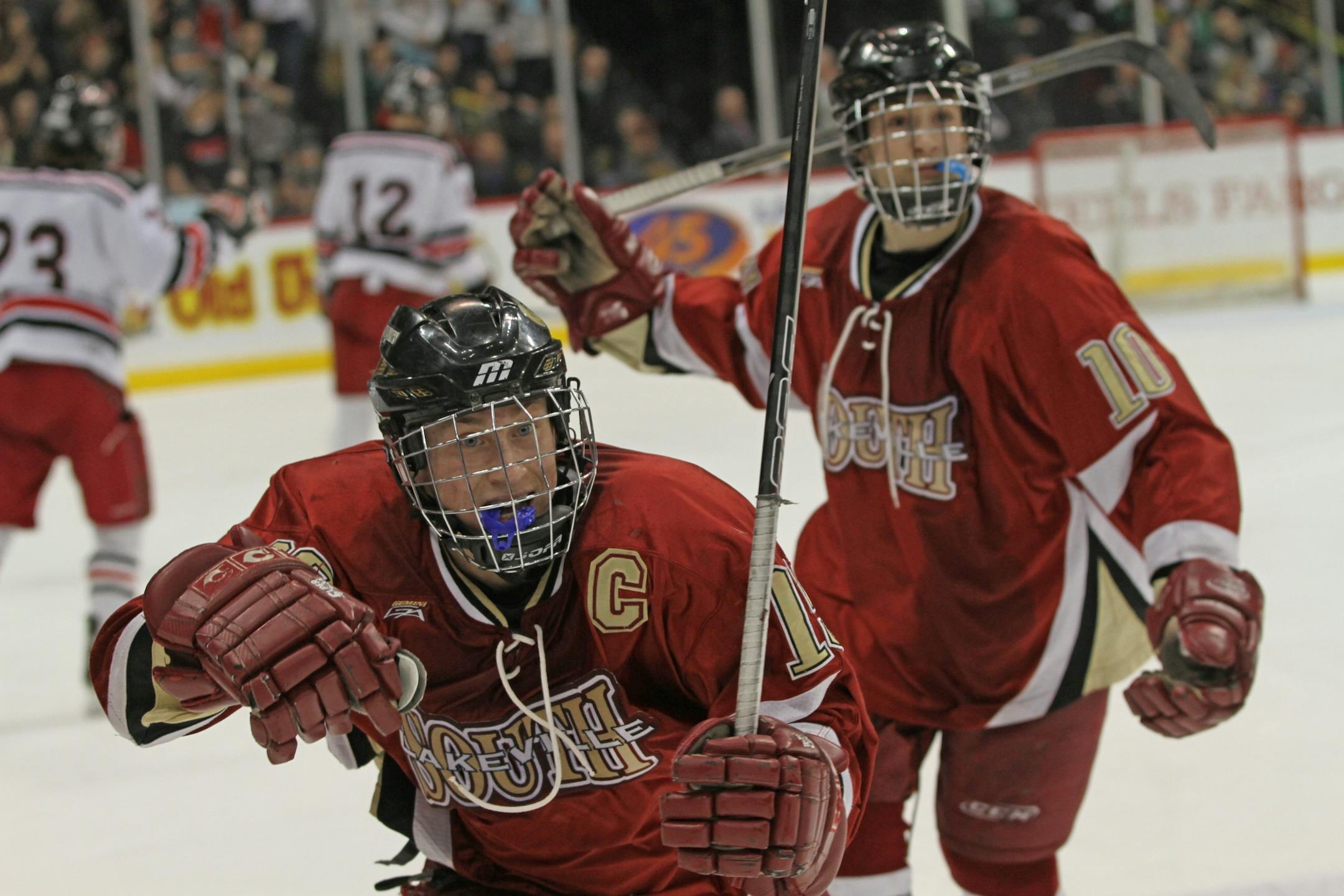 Lakeville South's Justin Kloos, left, celebrated a goal against Duluth East. in Thursday night's quarterfinal upset.