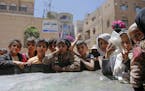 FILE - In this April, 13, 2017 file photo, Yemeni children wait to receive food rations provided by a local charity, in Sanaa, Yemen. Save the Childre