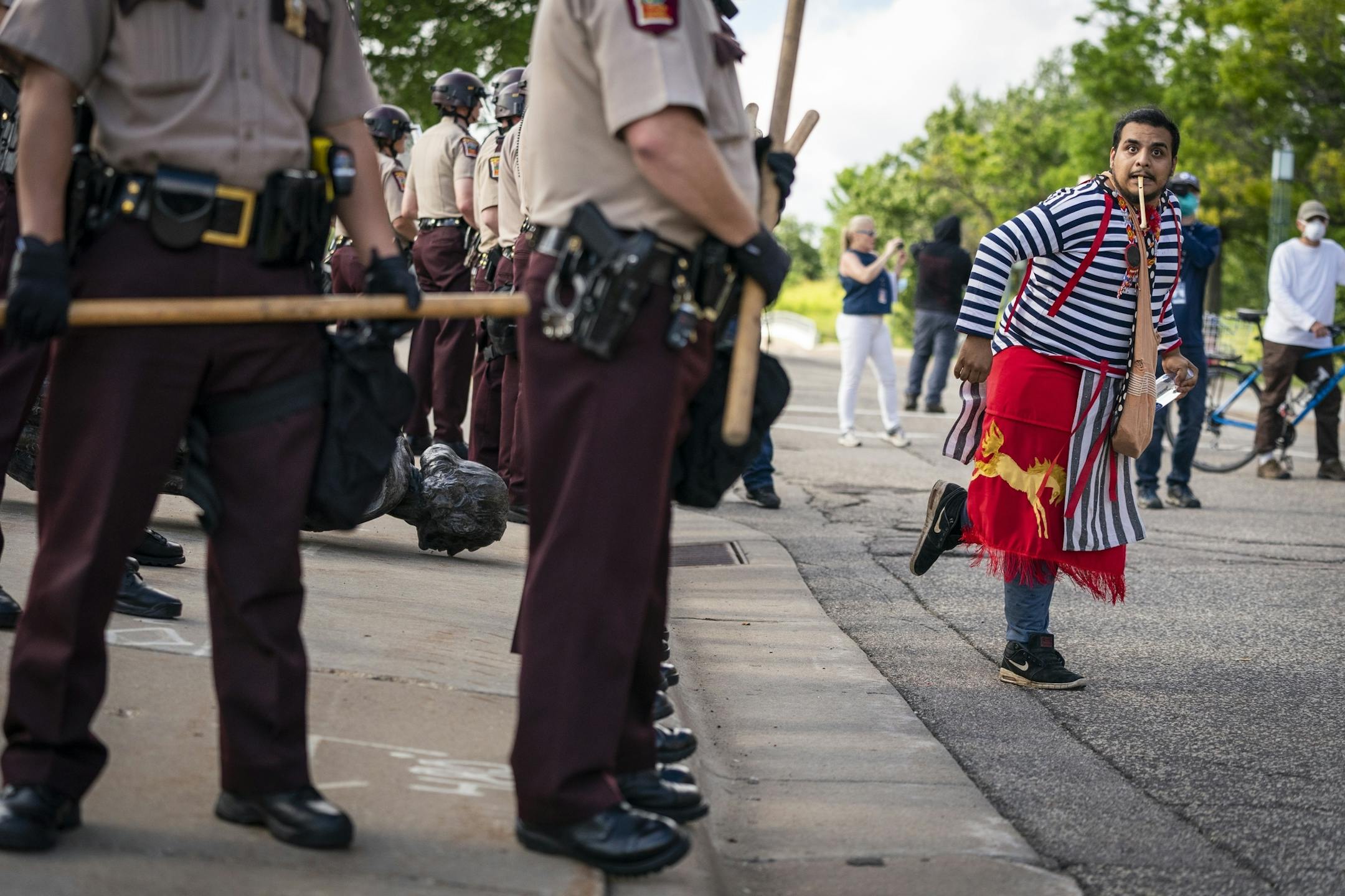 Hehaka Pejuta danced in front of Minnesota State Troopers as they surrounded the statue after it was toppled, until it could be taken away by a tow truck.
