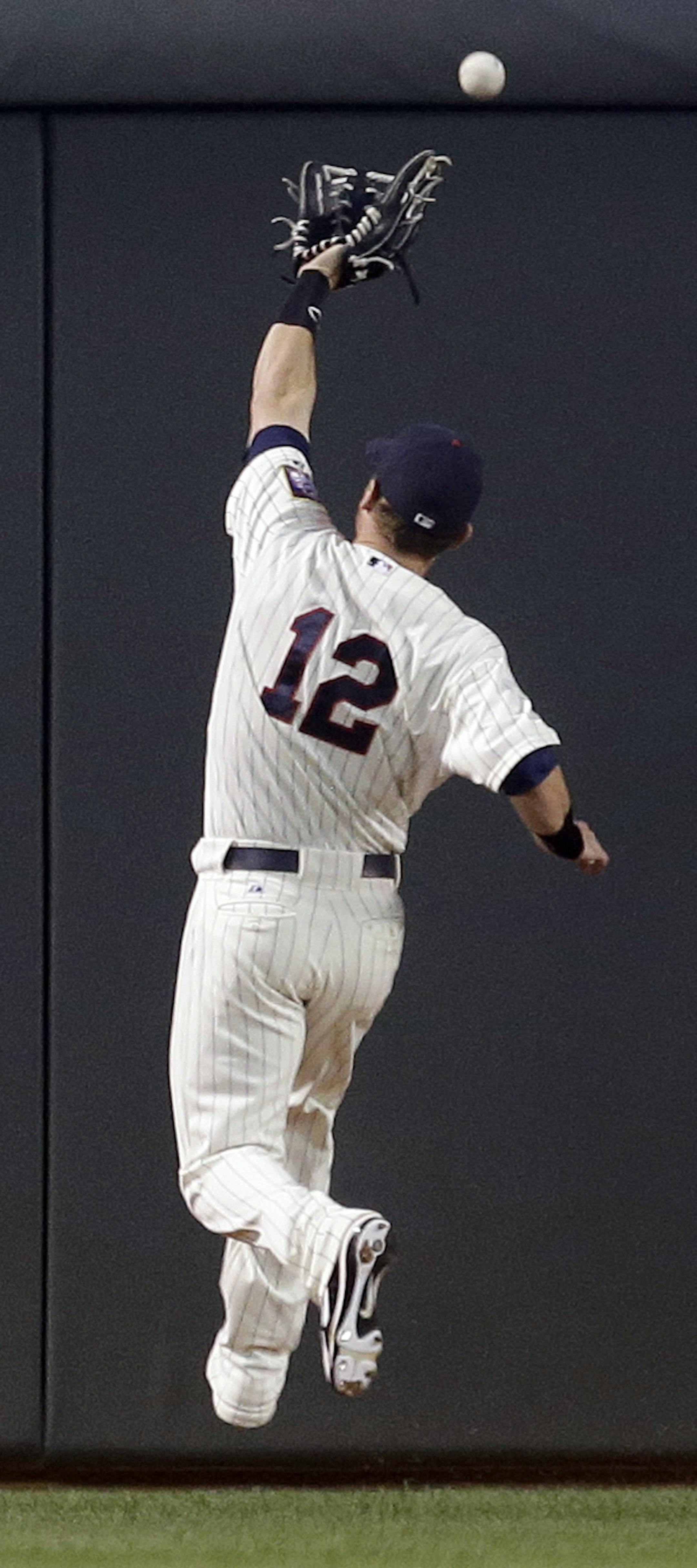 Minnesota Twins right fielder Chris Herrmann misses the catch as Detroit Tigers' Austin Jackson gets a triple during the first inning of a baseball game, Wednesday, Sept. 25, 2013, in Minneapolis. (AP Photo/Jim Mone)