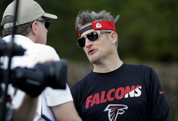 Atlanta Falcons general manager Thomas Dimitroff, right, visits during a practice for the NFL Super Bowl 51 football game Wednesday, Feb. 1, 2017, in 