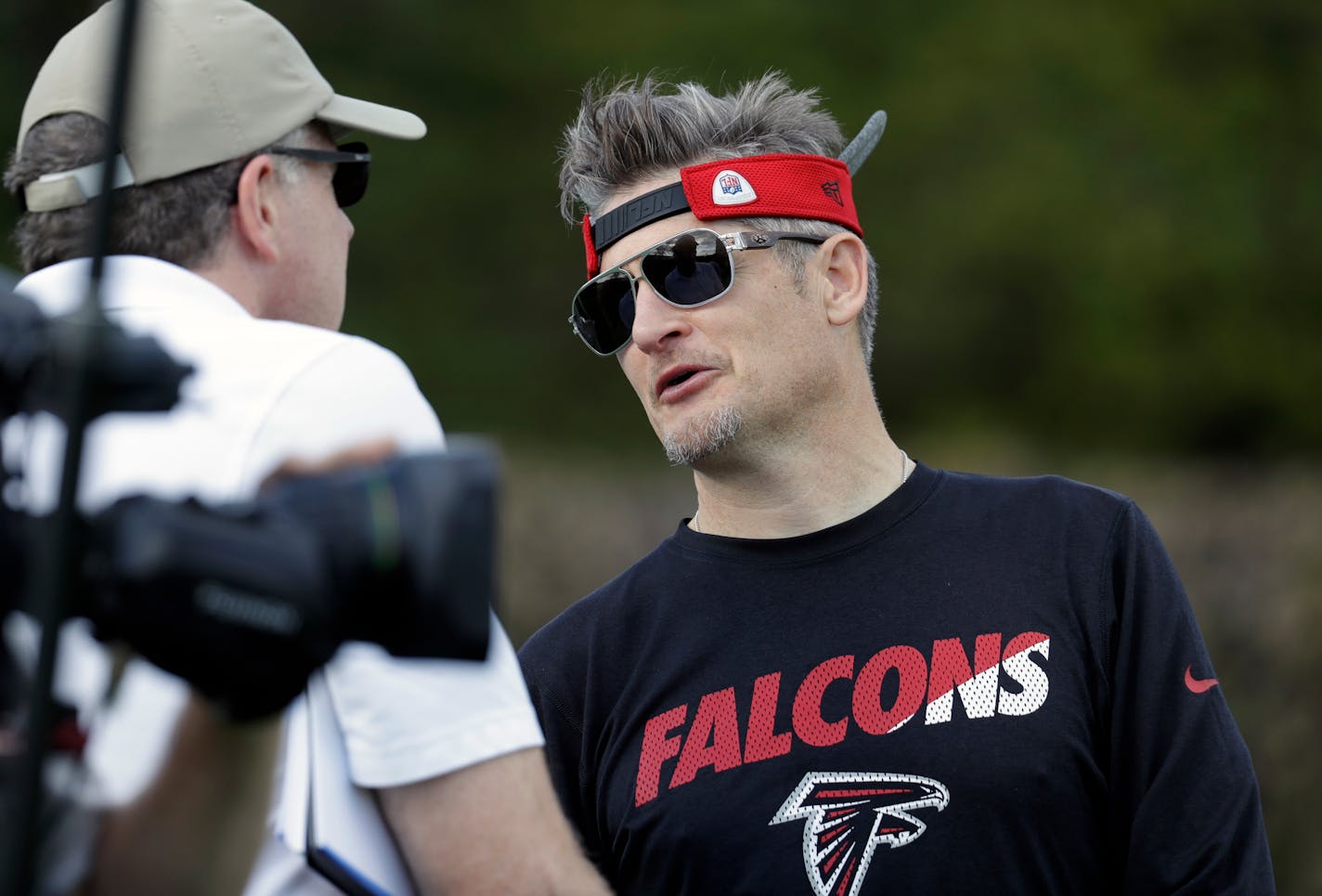 Atlanta Falcons general manager Thomas Dimitroff, right, visits during a practice for the NFL Super Bowl 51 football game Wednesday, Feb. 1, 2017, in Houston. Atlanta will face the New England Patriots in the Super Bowl Sunday. (AP Photo/Eric Gay)