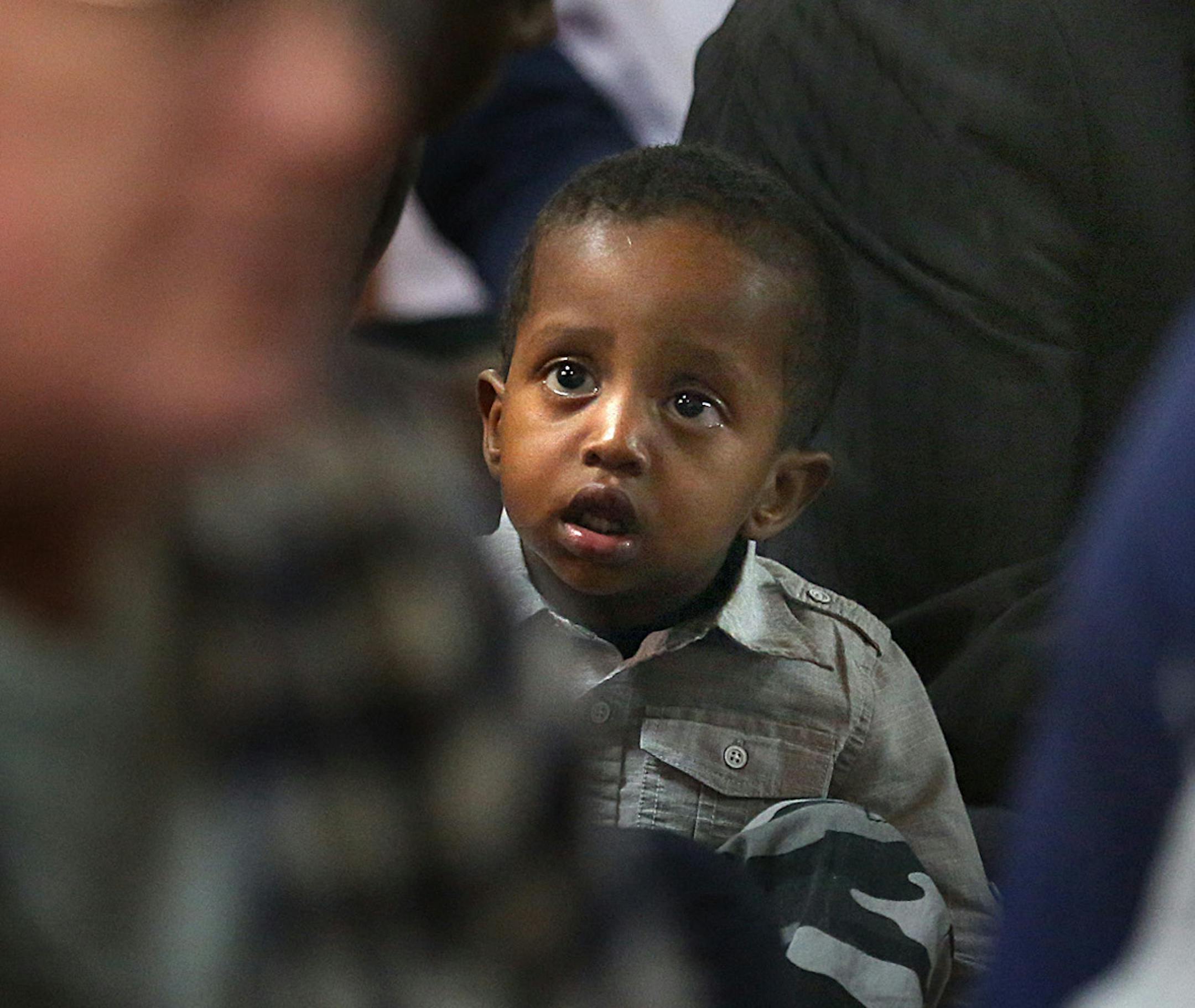 A child looked up during a prayer, where men were attending a mid-afternoon prayer and meeting at the Islamic Center of Minnesota in Columbia Heights. ] JIM GEHRZ ï james.gehrz@startribune.com / Columbia Heights, MN / October 2, 2015 / 12:00 PM ñ BACKGROUND INFORMATION: The Muslim families rallying in support of the new Quran school seemed to swallow up the opposition. Families with children, parents and grandparents filled nearly every chair, lined the walls and overflowed the Blaine