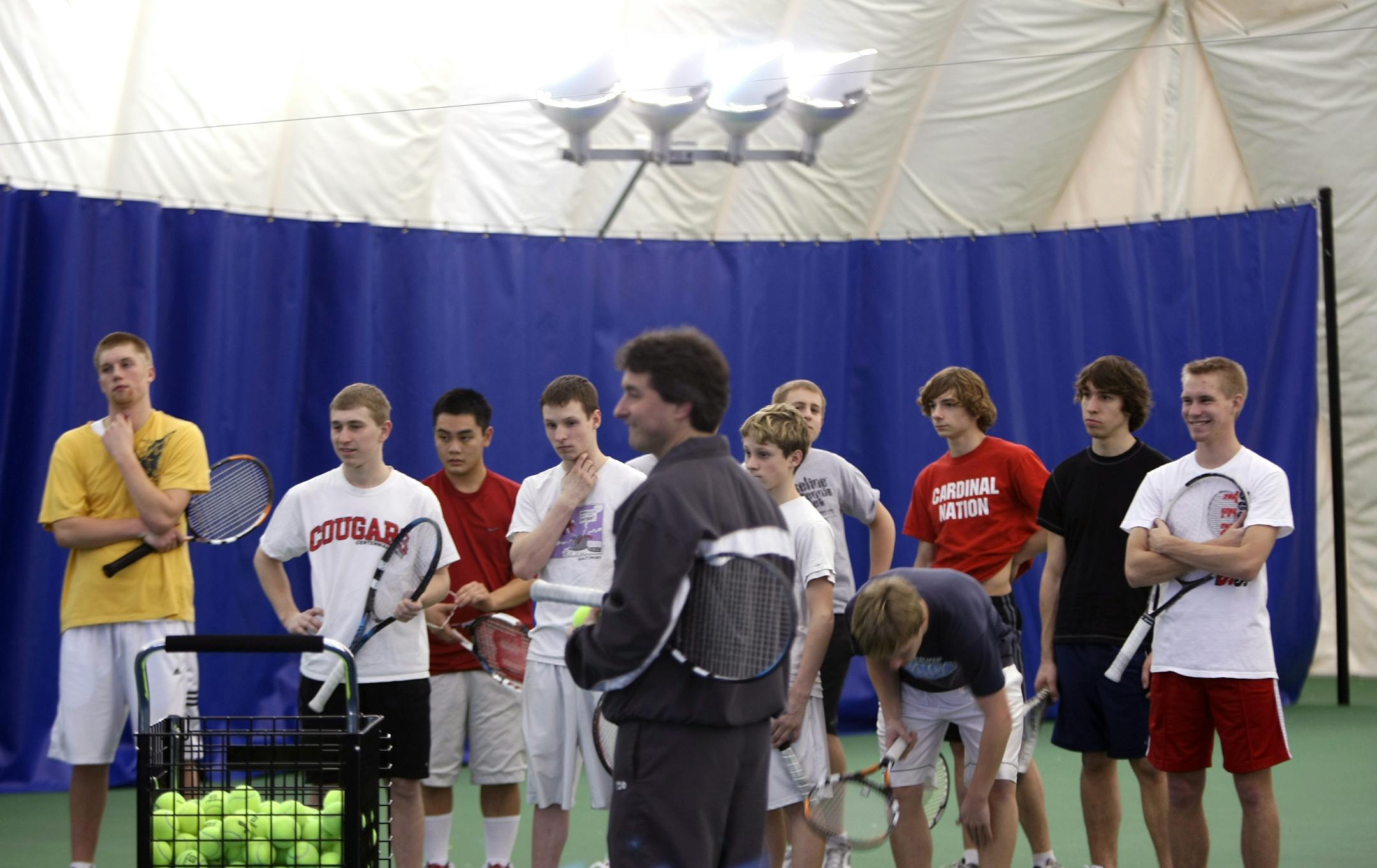 Tim Jachymowski, center, said the dome helps teens stay active. "I know that half of the kids that we have in our programs would be home watching TV rather than playing an hour and a half of tennis," he said.