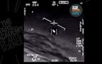 In this undated image made from video from a U.S. Navy aircraft and released by The Stars Academy of Arts & Science, an unidentified object moves near