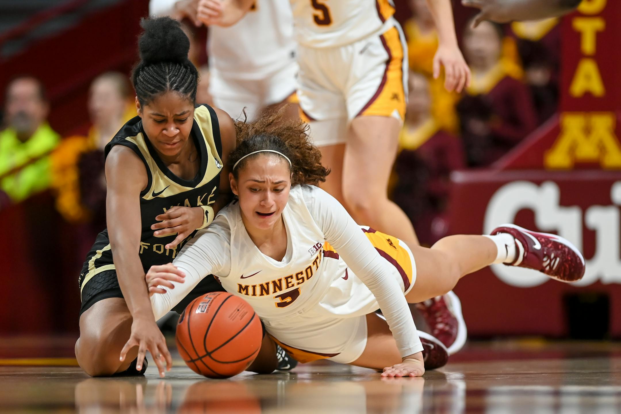 Wake Forest guard Jewel Spear (24) and Minnesota Gophers guard Amaya Battle (3) scramble for a loose ball during the second half.