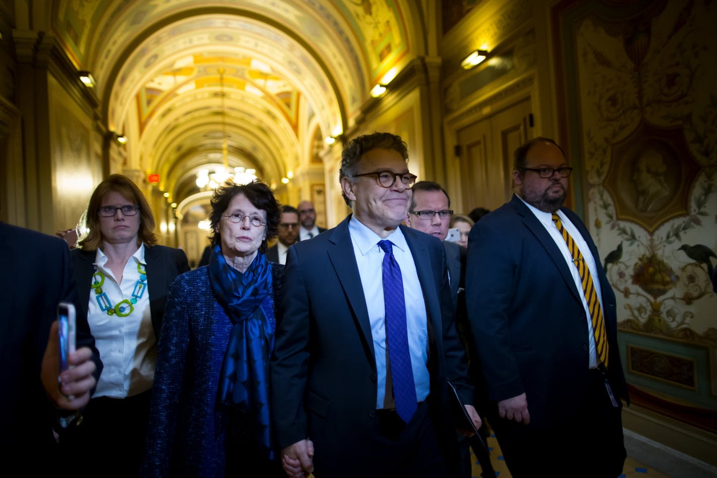 Sen. Al Franken is accompanied by his wife, Franni Bryson, as he arrives Thursday morning at the Capitol in Washington, Dec. 7, 2017. Franken announced Thursday he would resign from the Senate after his support among Democrats crumbled, becoming the highest-profile casualty in the growing list of lawmakers felled by charges of sexual harassment or indiscretions.