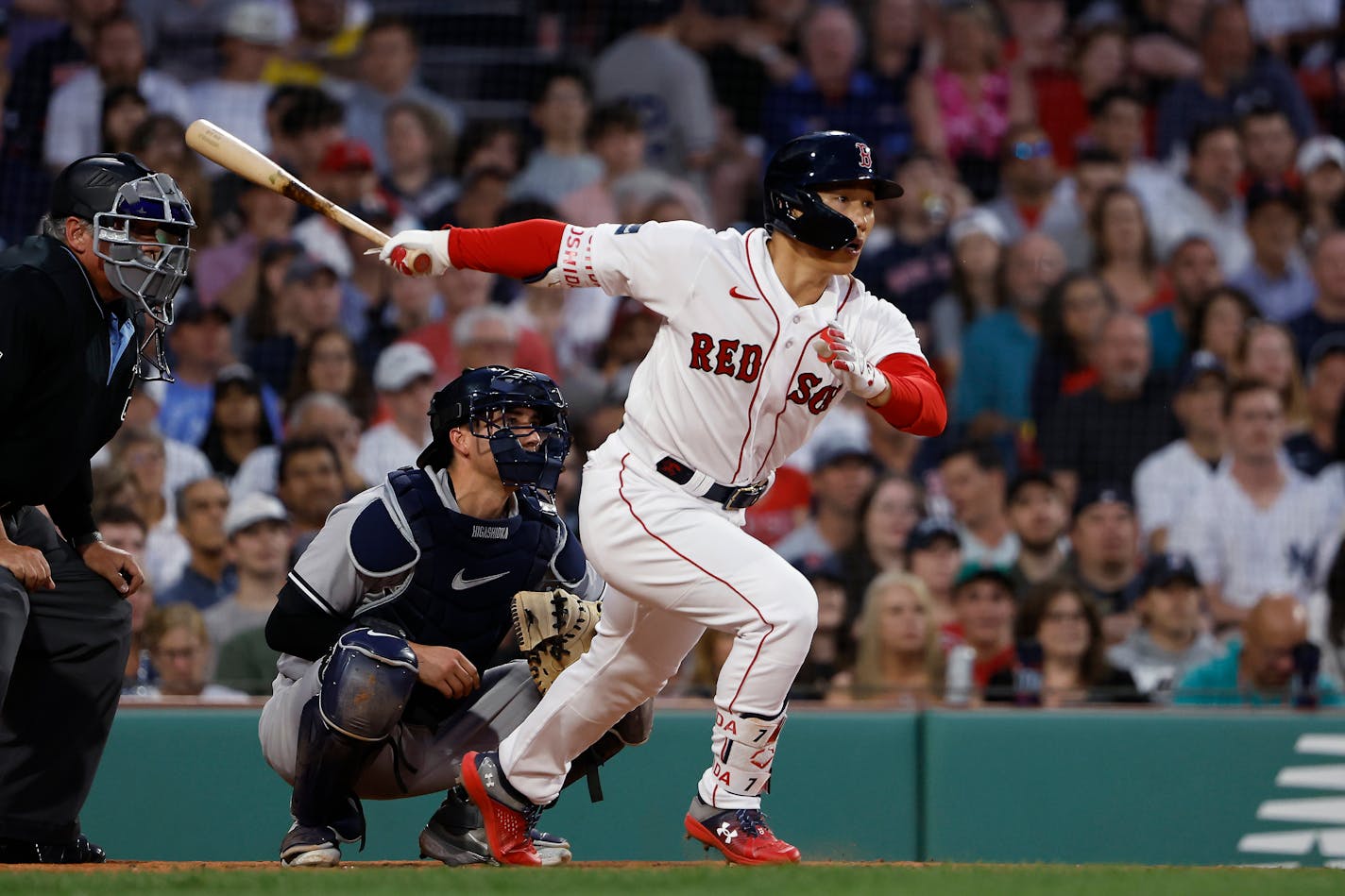 Boston Red Sox's Masataka Yoshida follows through on an RBI single against the New York Yankees during the third inning of a baseball game Friday, June 16, 2023, at Fenway Park in Boston. (AP Photo/Winslow Townson)