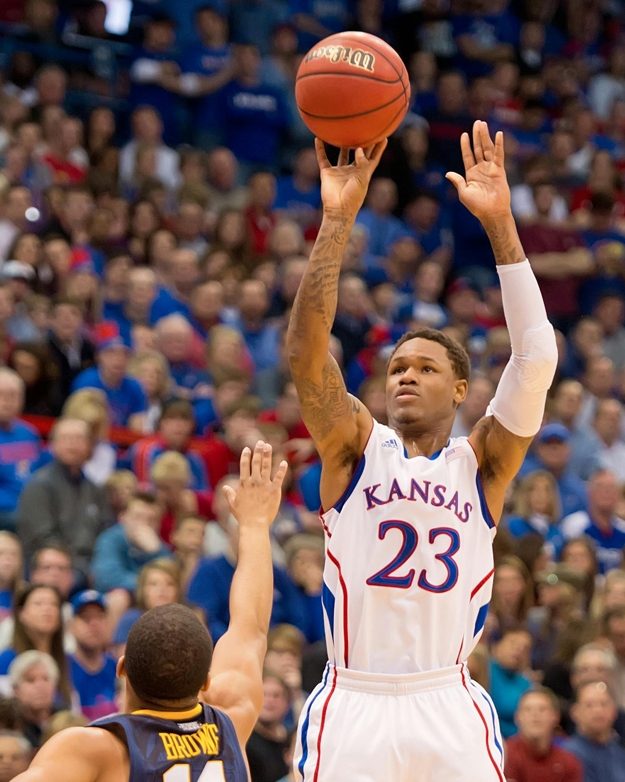 Kansas Jayhawks guard Ben McLemore (23) hits a three-point basket over West Virginia Mountaineers guard Gary Browne (14) in the first half at Allen Fieldhouse in Lawrence, Kansas, Saturday, March 2, 2013. Kansas defeated West Virginia, 91-65. (David Eulitt/Kansas City Star/MCT)