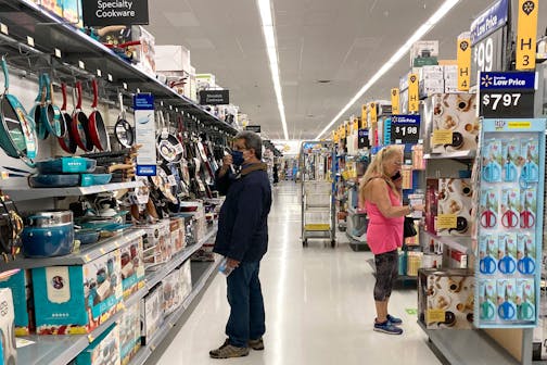 FILE - Consumers shop at a Walmart store in Vernon Hills, Ill., Sunday, May 23, 2021. U.S. consumer confidence fell in August to the lowest level since February amid rising concerns about the rapidly spreading delta variant of the coronavirus and worries about higher inflation. The Conference Board reported Tuesday, Aug. 31, 2021 that its consumer confidence index dropped to a reading of 113.8 in August, down from a revised 125.1 in July. (AP Photo/Nam Y. Huh, file)