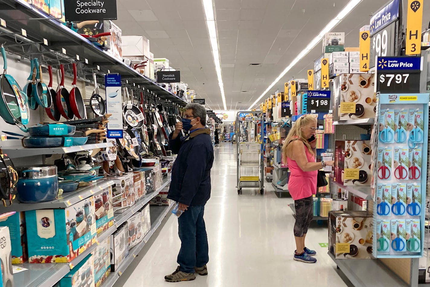 FILE - Consumers shop at a Walmart store in Vernon Hills, Ill., Sunday, May 23, 2021. U.S. consumer confidence fell in August to the lowest level since February amid rising concerns about the rapidly spreading delta variant of the coronavirus and worries about higher inflation. The Conference Board reported Tuesday, Aug. 31, 2021 that its consumer confidence index dropped to a reading of 113.8 in August, down from a revised 125.1 in July. (AP Photo/Nam Y. Huh, file)