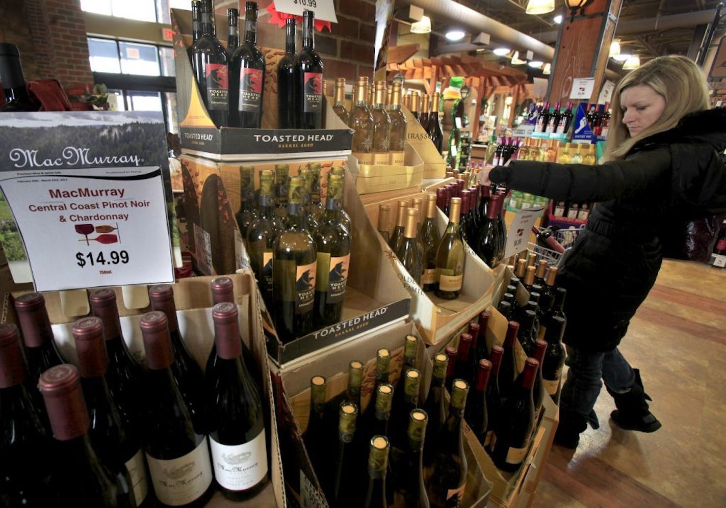 Tami Ross shopped for wine at the Lakeville Municipal Liquor Store in 2013. With $15.28 million in sales, Lakeville topped the list of the 190 Minnesota cities that run their own liquor stores.