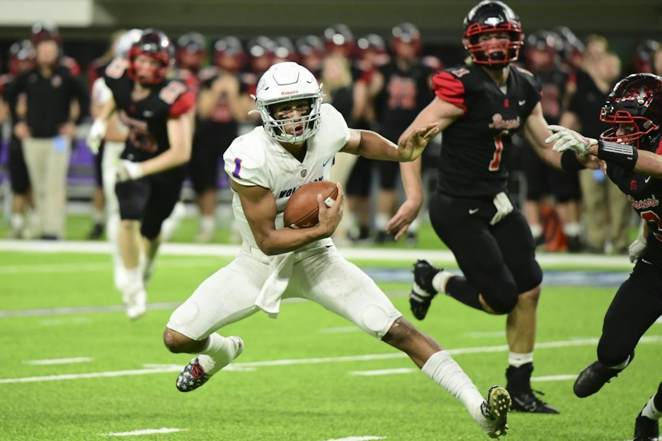 SMB Wolfpack quarterback Jalen Suggs (1) ran the ball for a first down in the first quarter against Rocori.