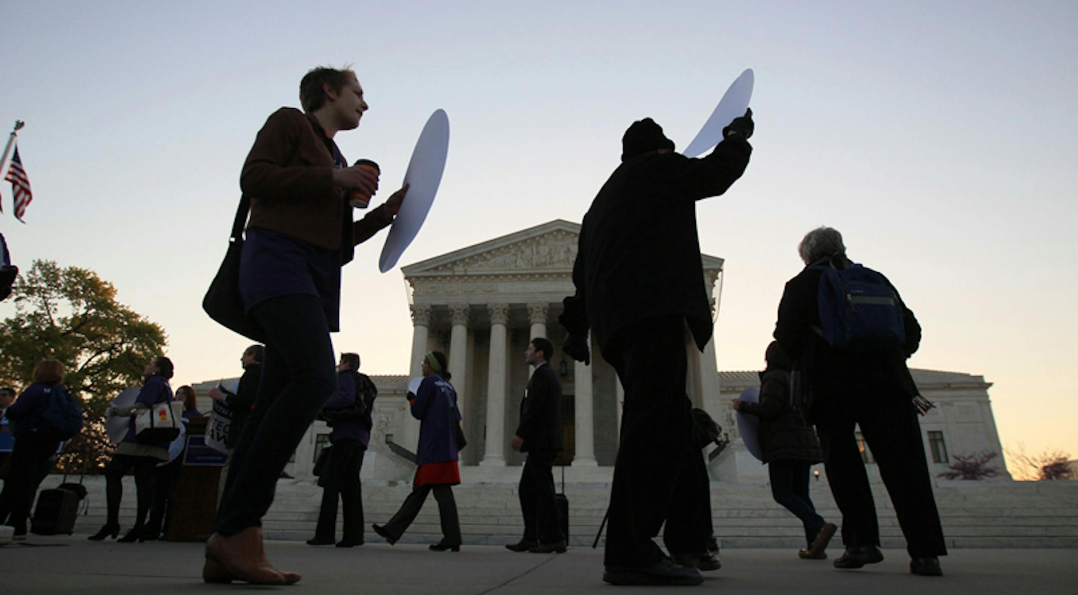 Supporters and opponents of the health care law demonstrate outside the Supreme Court in Washington, March 27, 2012.