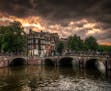 The traveler: Ryan Karlstad of Stillwater, MN The scene: Cloudy skies hasten the darkness that settles over a canal in Amsterdam at dusk. The trip: My