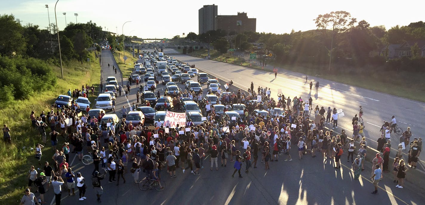 FILE - In this July 9, 2016 file photo, marchers block part of Interstate 94 in St. Paul, Minn., during a protest sparked by the recent police killings of black men in Minnesota and Louisiana. The killing of Philando Castile by a Minnesota police officer during a traffic stop last week tore open wounds that hadn't yet healed in Minnesota's black community from a previous officer-involved death last year. (Glen Stubbe/Star Tribune via AP, File)